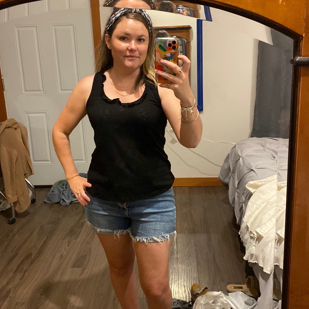 Soft stretchy black tank with ruffle detail at the neck. Super versatile & easy!